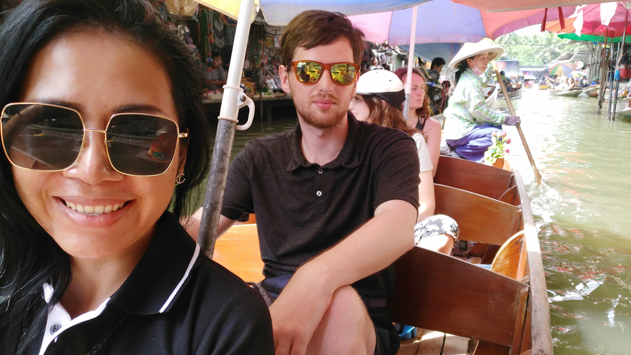 People on a boat at a floating market.