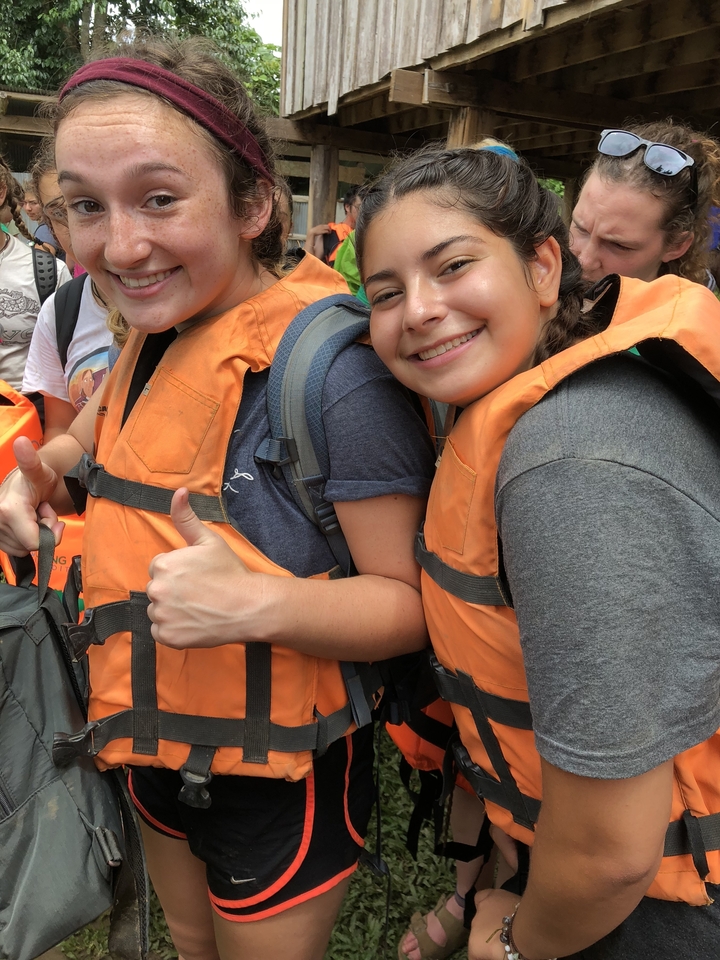 People in life vests giving thumbs up.