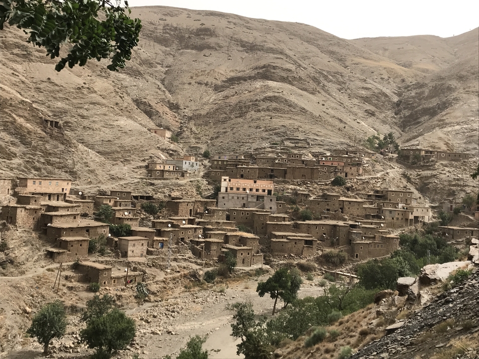 A mountain village with houses built into the hillside.