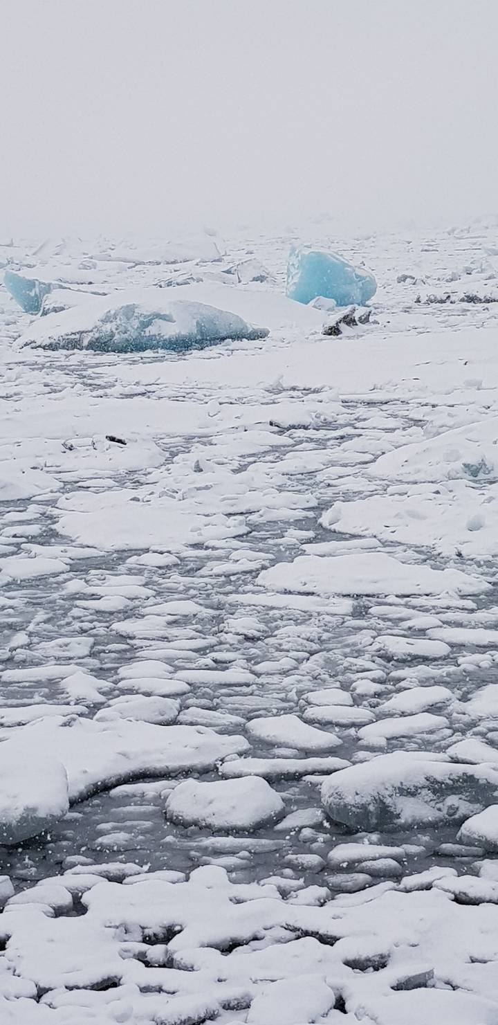 Frozen icy landscape with visible glaciers.