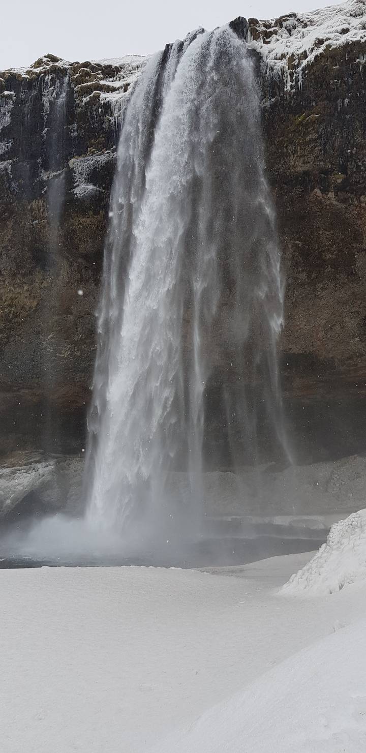 Frozen waterfall cascading over a cliff.
