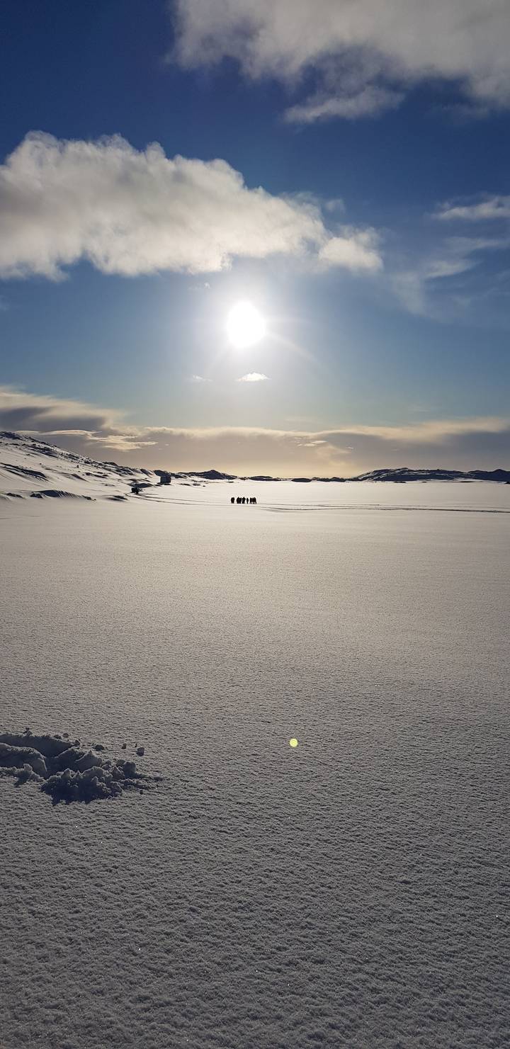 Sun rising over a vast snow-covered landscape.