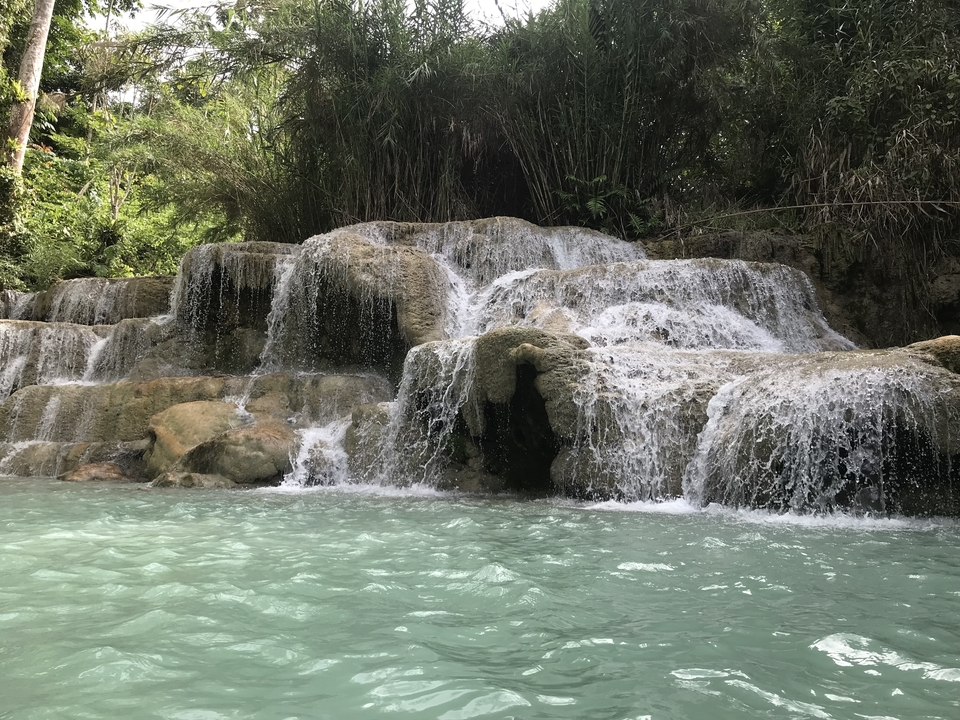 Beautiful cascading waterfall surrounded by lush greenery.