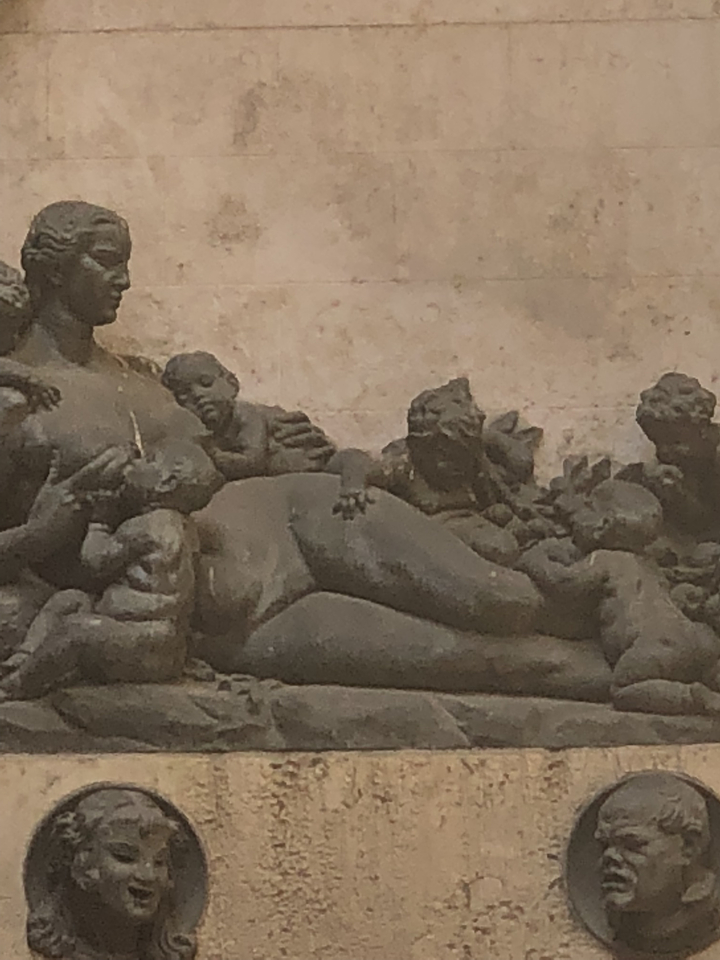 Close-up of a detailed stone sculpture featuring human figures.