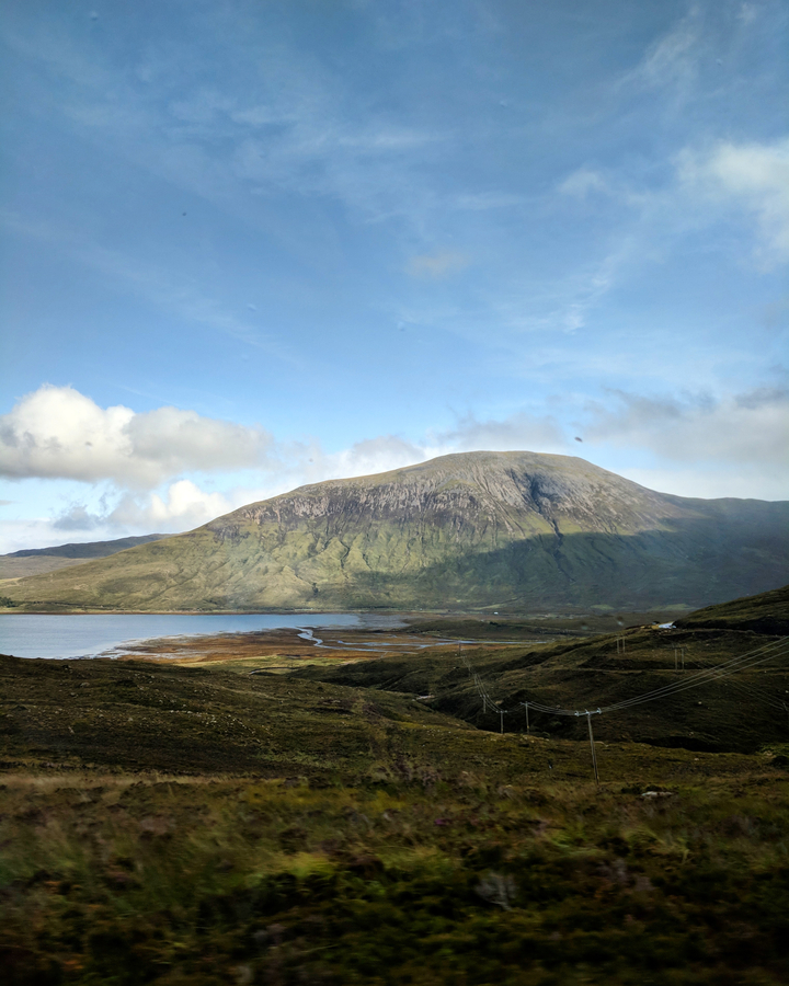 Large mountain in a scenic landscape with a lake.