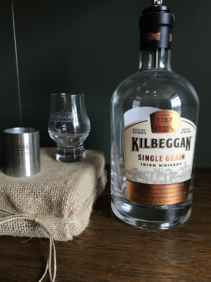 Whiskey bottle and glass with brand name visible.