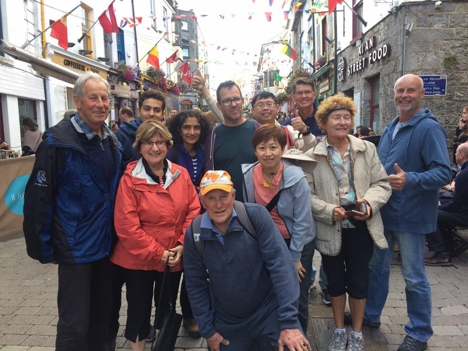Group of tourists posing in a lively street.