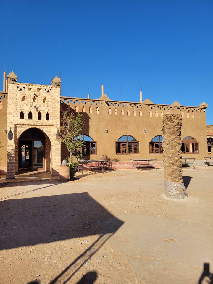 Building in a desert setting with a blue sky.