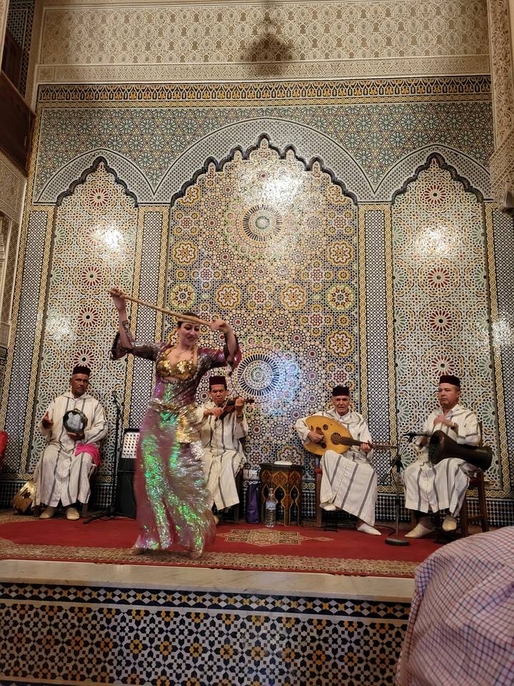 Cultural dance performance inside a vibrant hall.