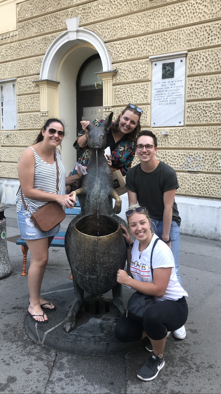 Group posing at a statue fountain.