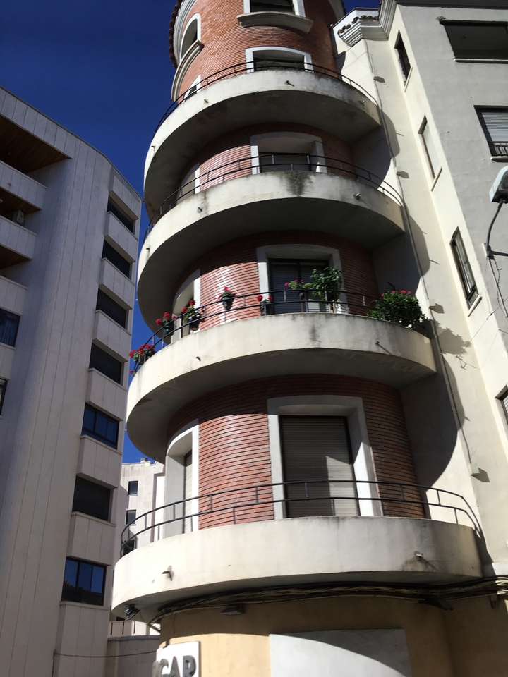 Modern architectural building with circular balconies.