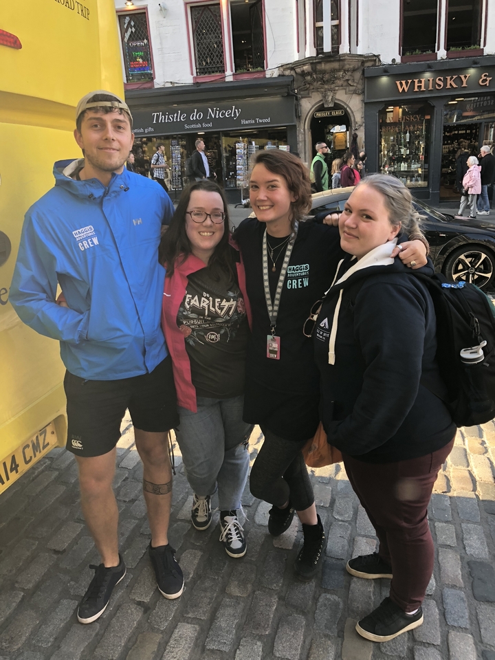 Group of people posing together outdoors.