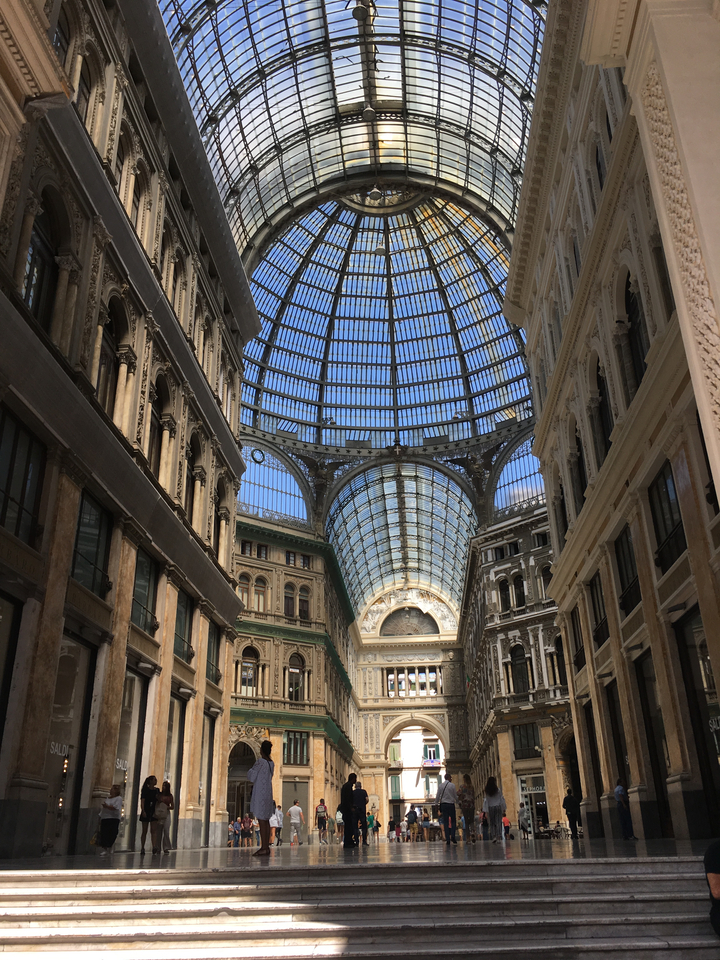 Ornate indoor architecture with a glass dome ceiling.