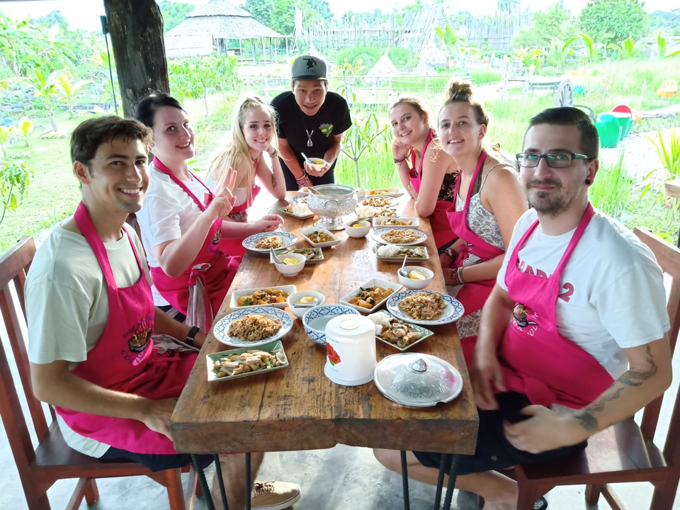 People sitting around a table with traditional dishes.