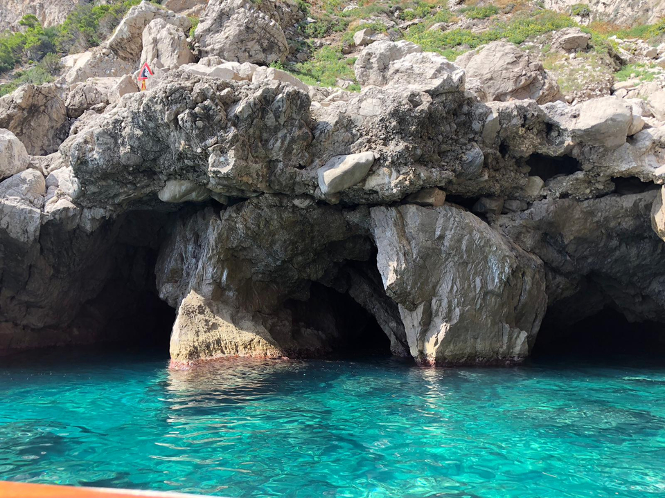 Rock formations by the clear blue sea.