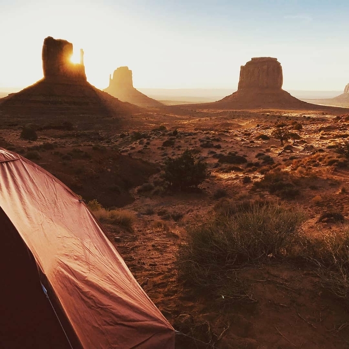 Sunset view of Monument Valley with a tent.