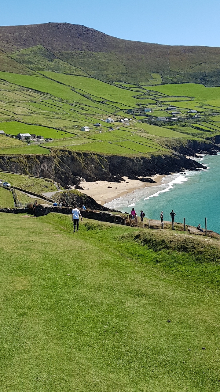 People enjoying a coastal view with beach.