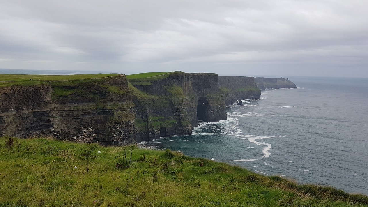 Cliffs of Moher with waves crashing.