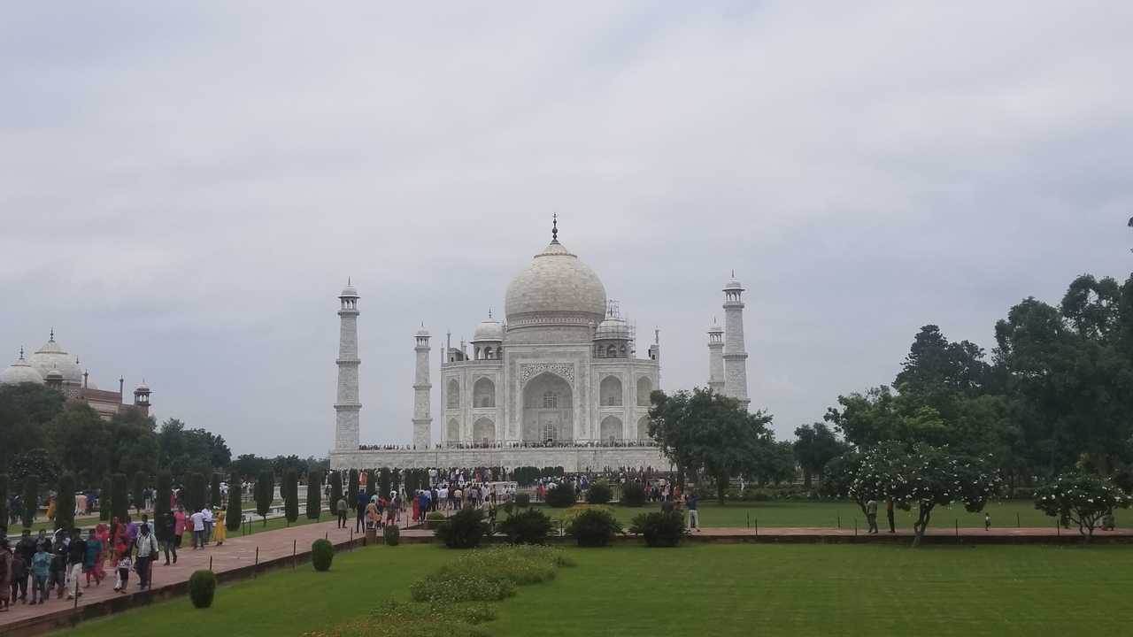 View of the Taj Mahal with visitors in the foreground.