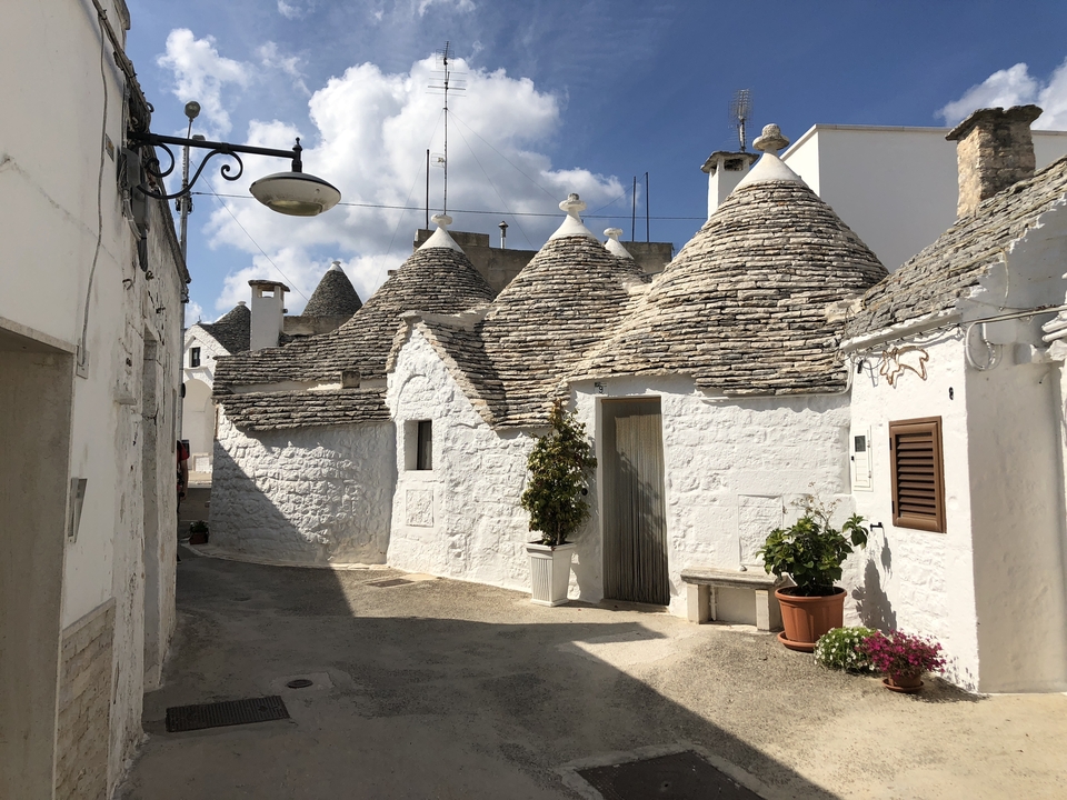 Trulli houses in a quaint alley in Alberobello.