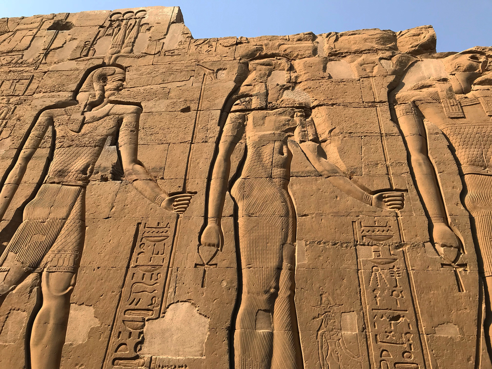 Ancient Egyptian carvings in a temple wall.