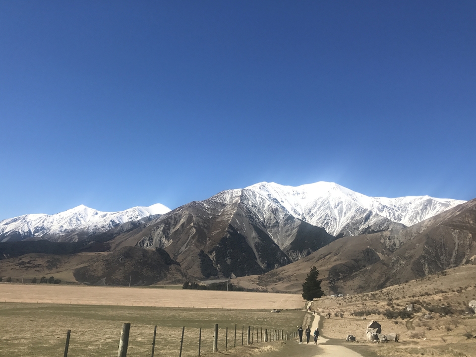 Snow-covered mountains under a clear blue sky.
