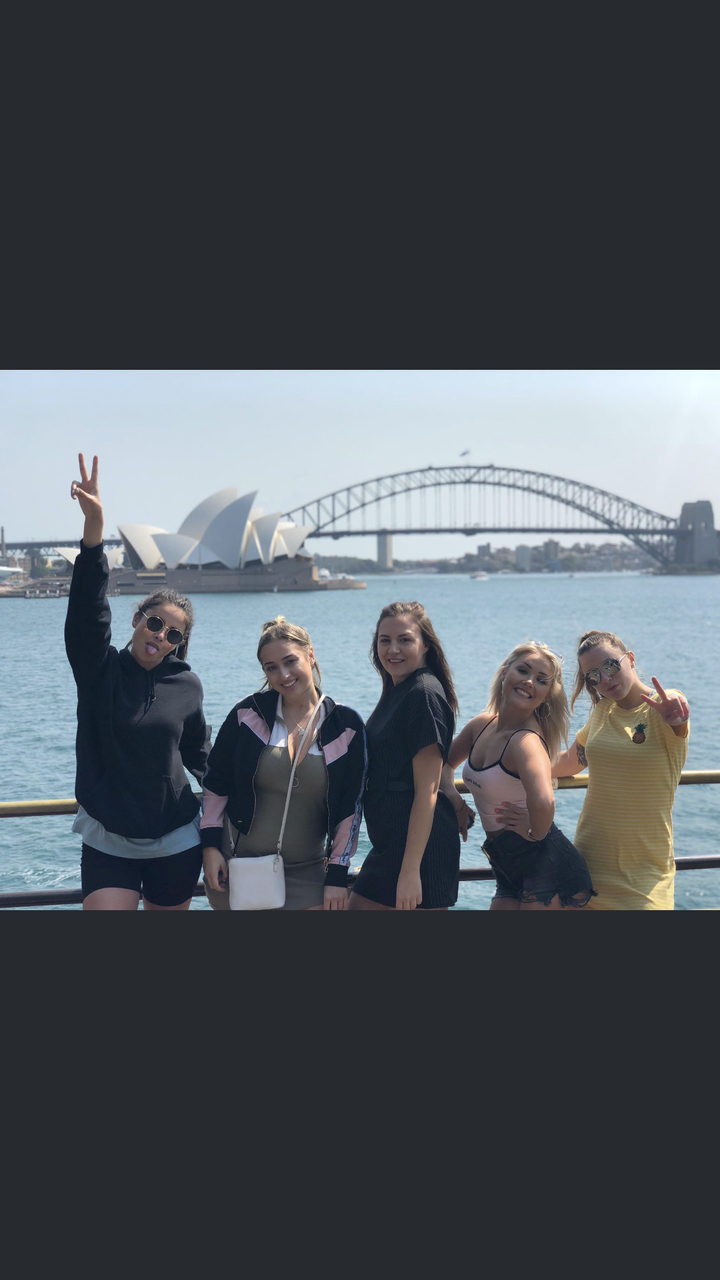 Group posing in front of the Sydney Opera House and Harbour Bridge.