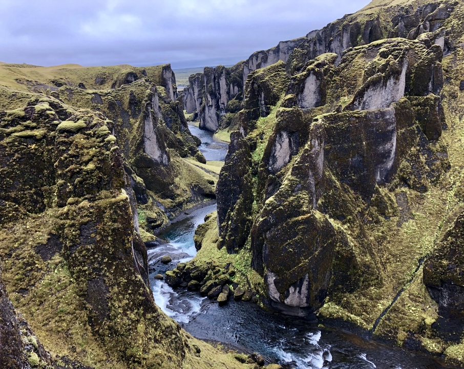 Aerial view of spectacular moss-covered canyon with a river.