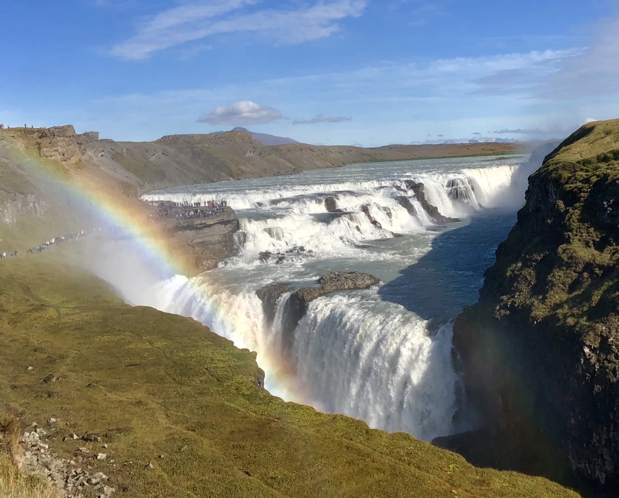 Gullfoss waterfall with rainbow arching across the mist.