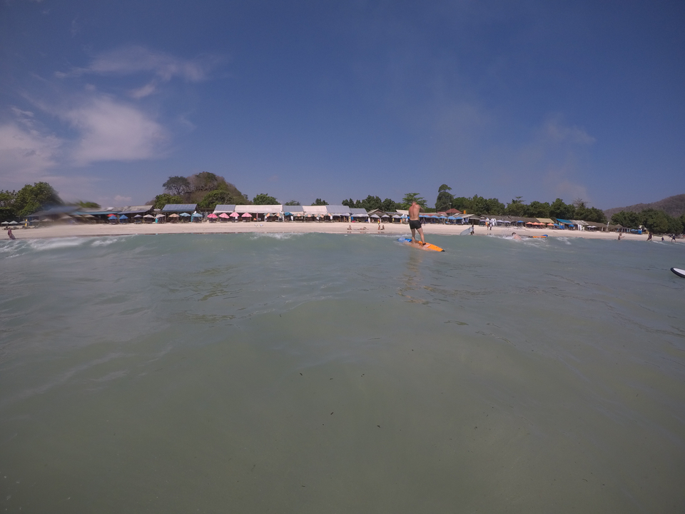 Coastal view from the water with a beach in the distance.