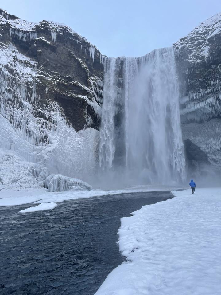Waterfall surrounded by ice and snow