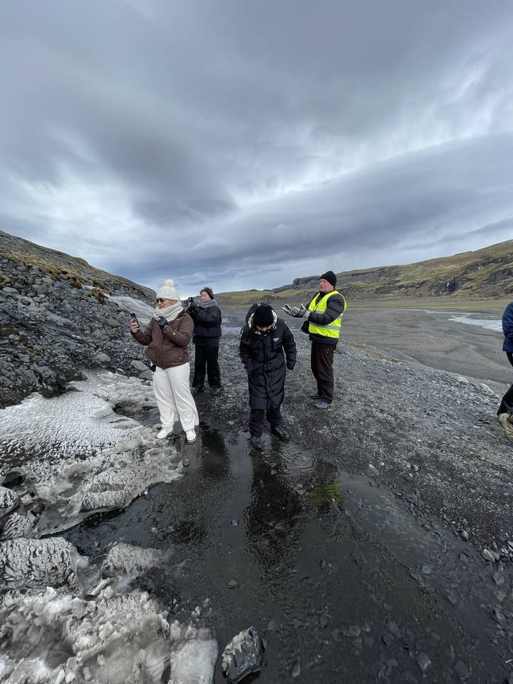 Group of people walking on an icy landscape.