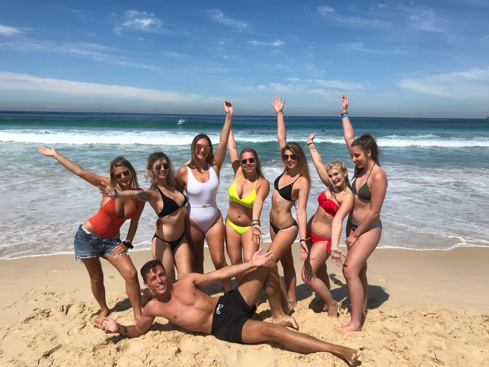 Group of friends posing on a sunny beach.