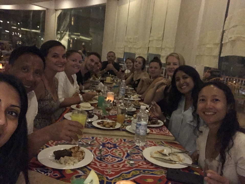 Group dining at a large table with food.