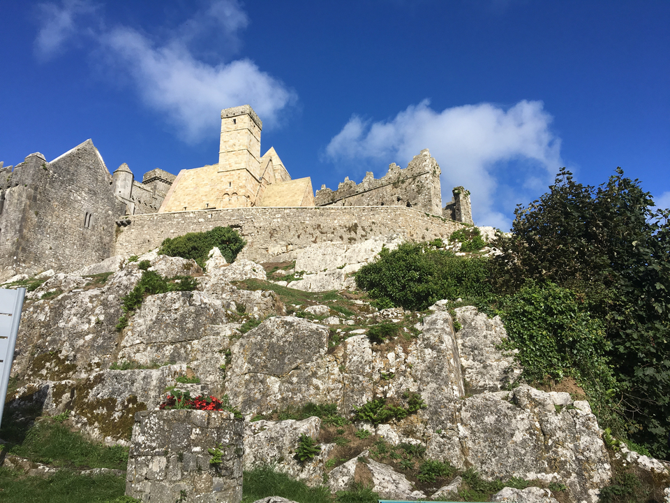 Fortress on a hill with rocky terrain and blue sky