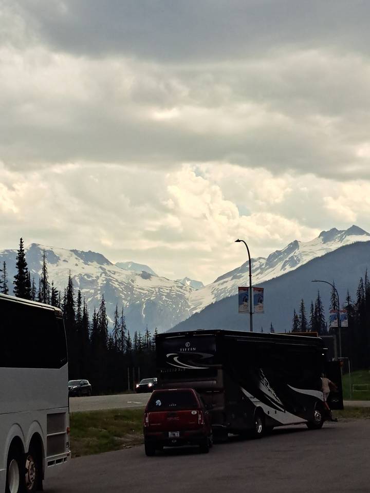 Snowy mountain landscape with gathering clouds.