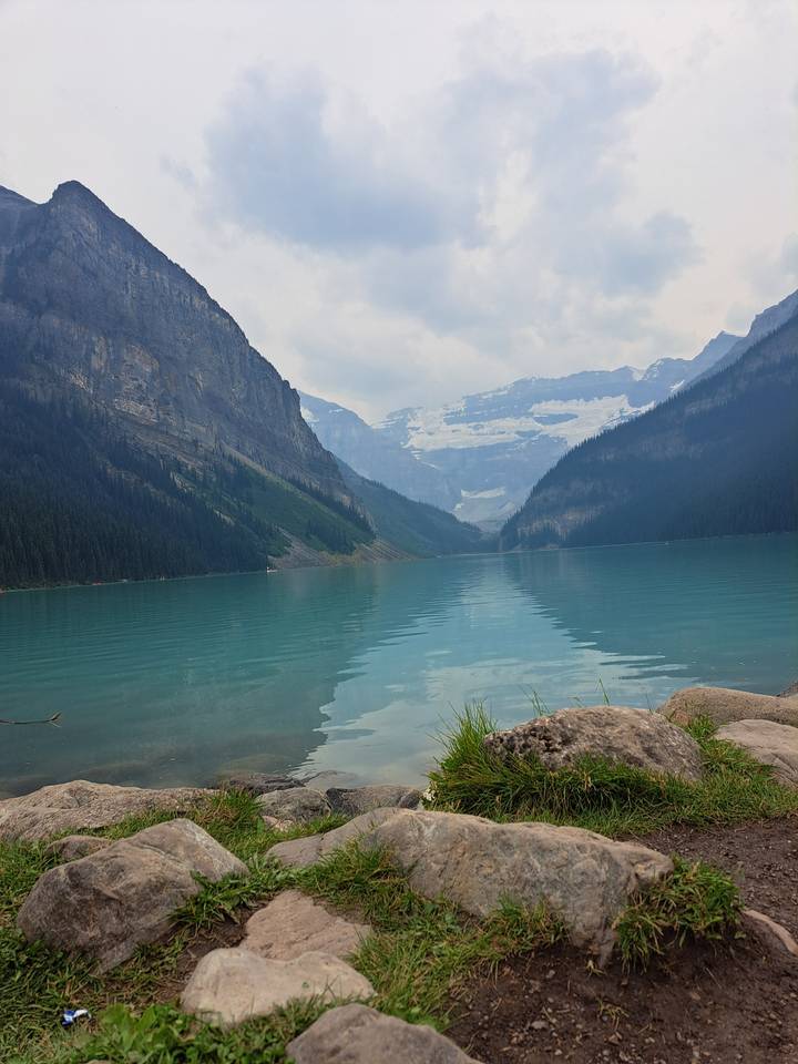 Mountain reflected in a clear lake with forested shoreline.