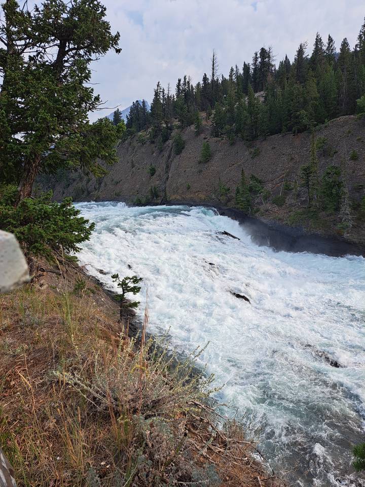 Flowing waterfall over rocky terrain.