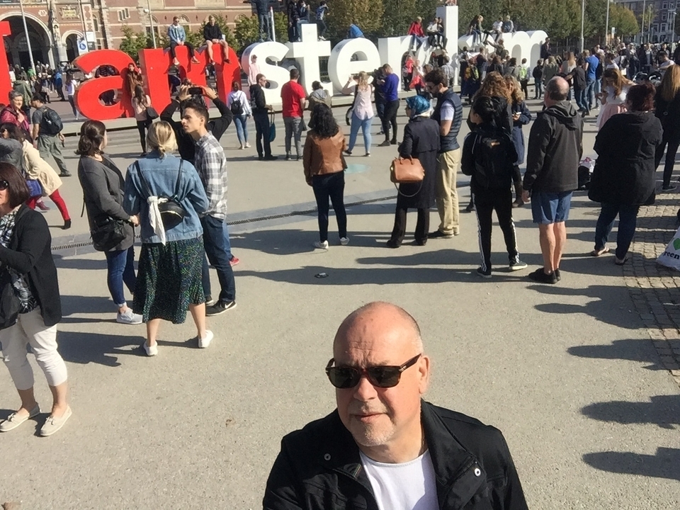 Visitors gathered around a large red letter sculpture.