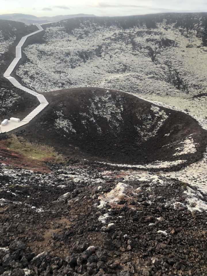 Crater with a staircase beside it.