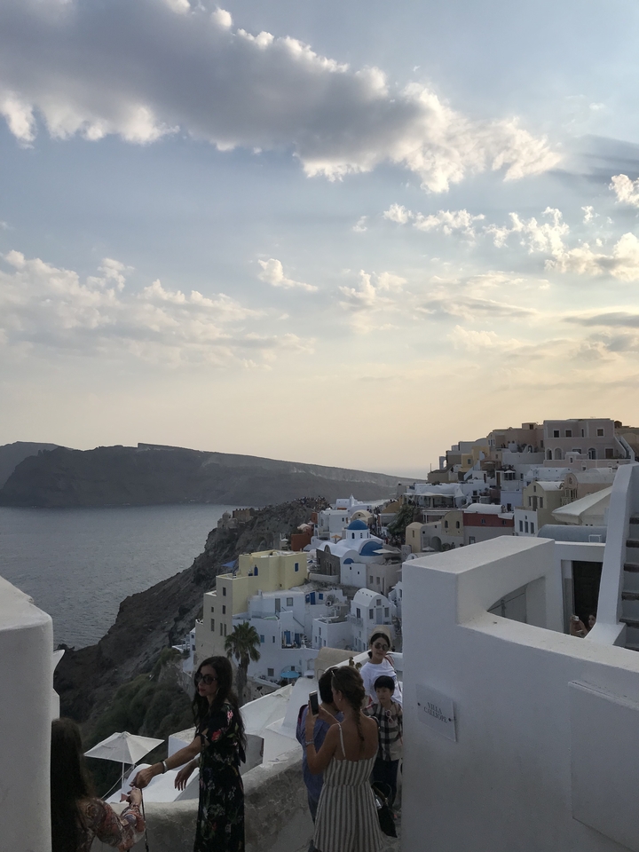 Oia village perched on the cliffs of Santorini overlooking the sea.