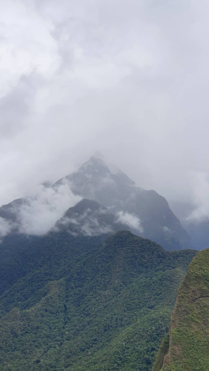 Mountainous landscape obscured by clouds.
