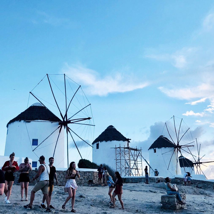 Group in front of iconic white windmills.