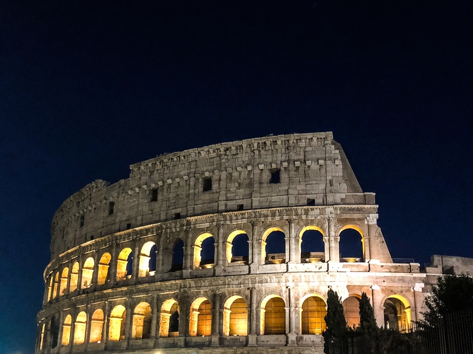 Illuminated Roman Colosseum at night.