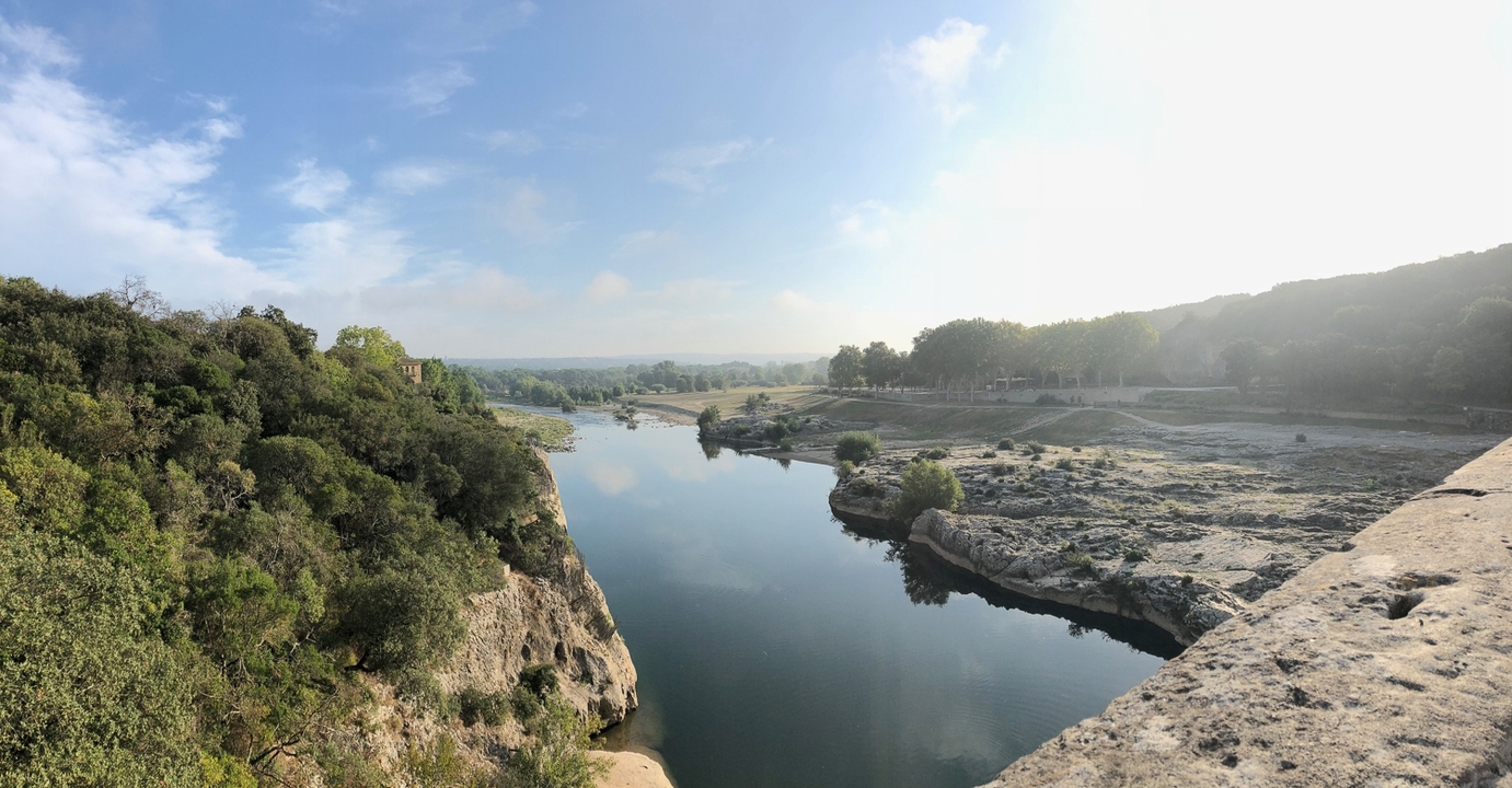 River landscape with clear sky and distant trees.
