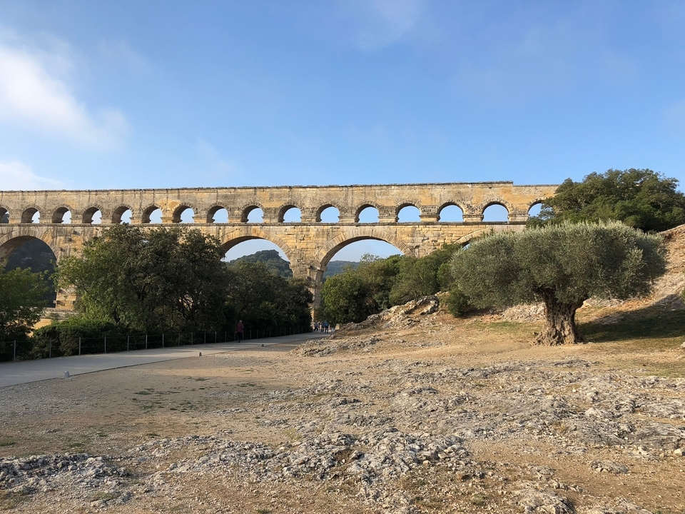 Ancient stone aqueduct with clear sky.