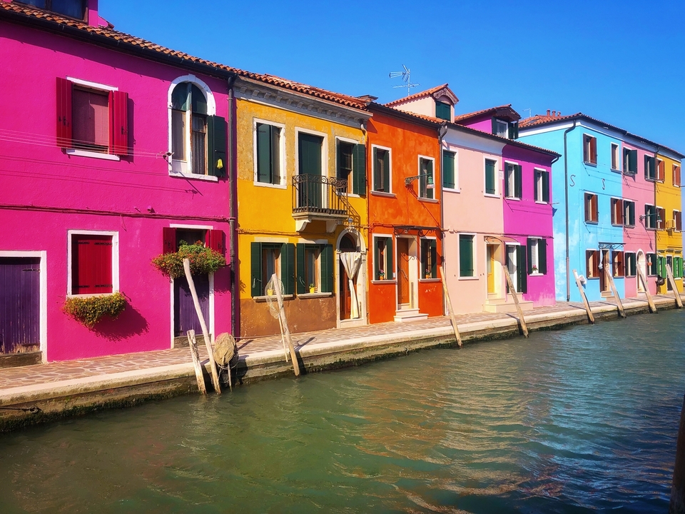 Colorful houses alongside canal.