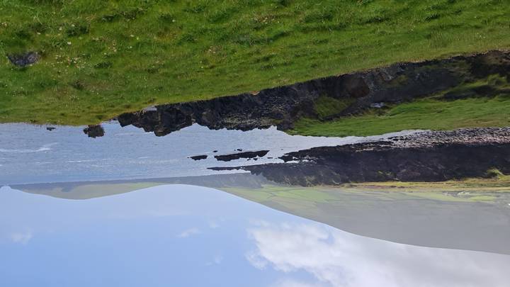 An ocean view with rocky shores.