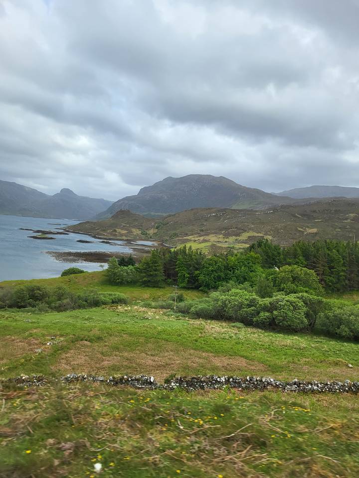 A scenic view of a road passing through a green landscape.