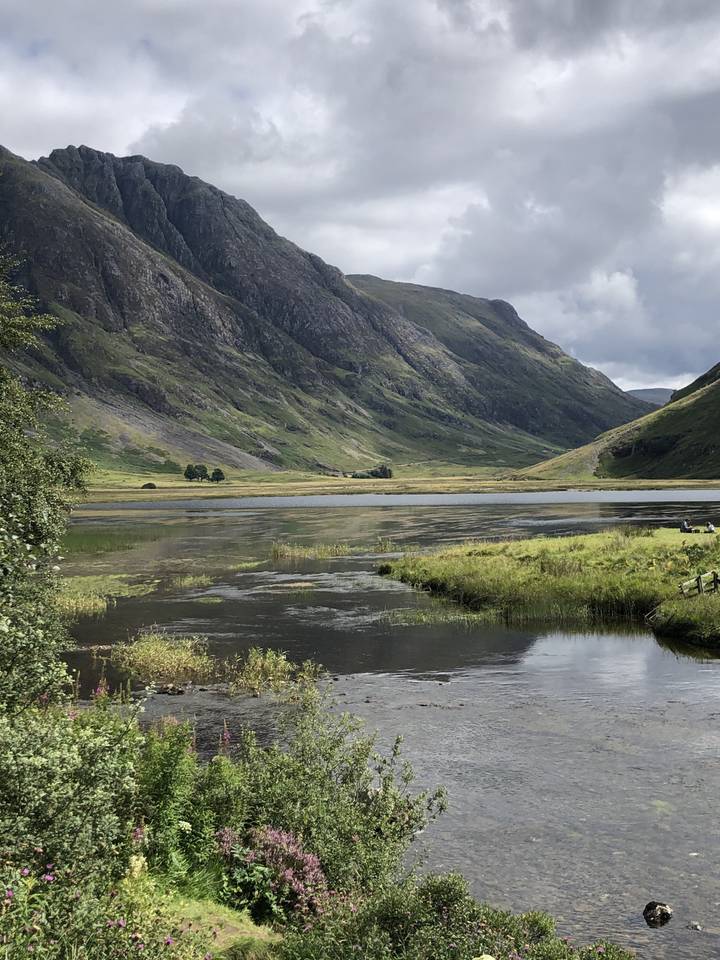 Scenic view of a lake surrounded by mountains.